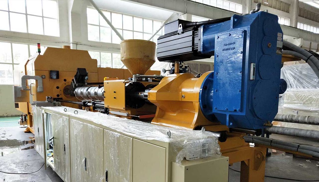 Close up of a Rubber Extruding machine that is using a Transcyko brand Helical Gearbox to control movement